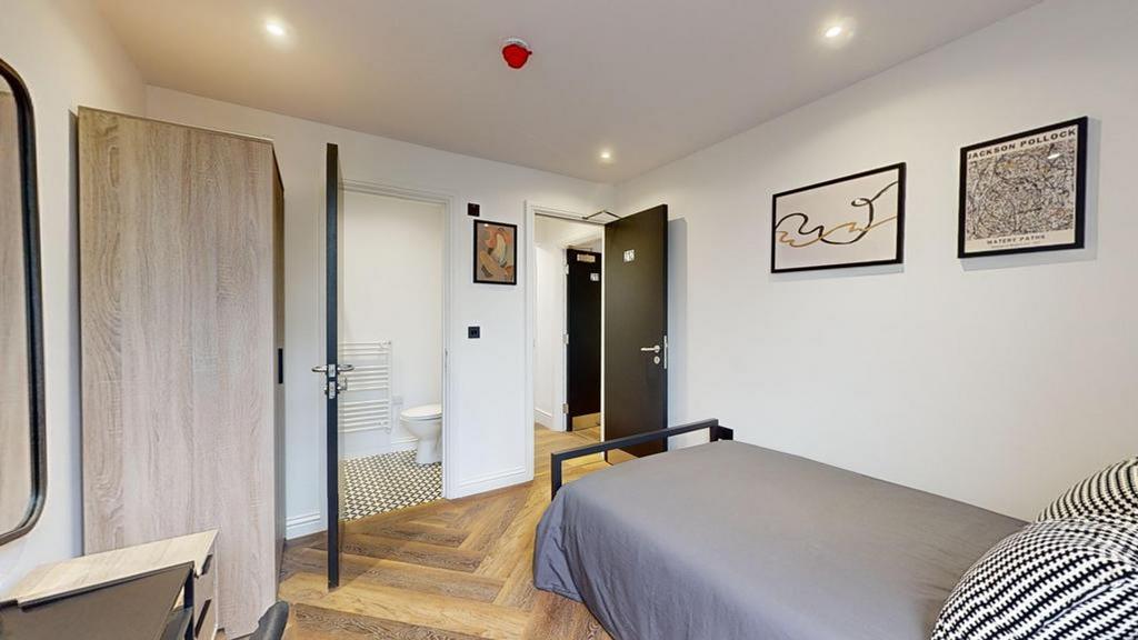 A bright and tidy single bedroom featuring a co...