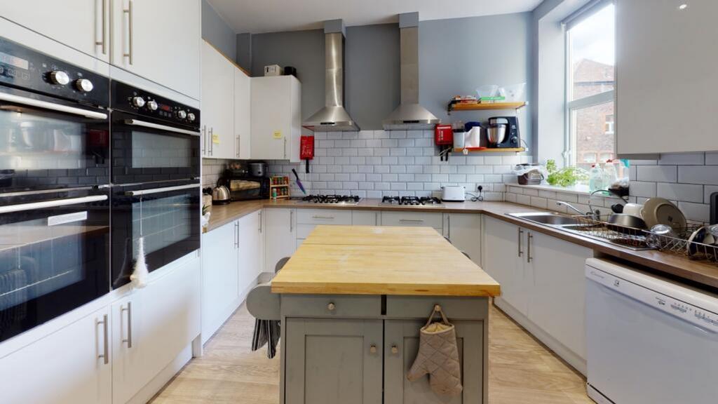 A modern kitchen featuring a spacious central i...