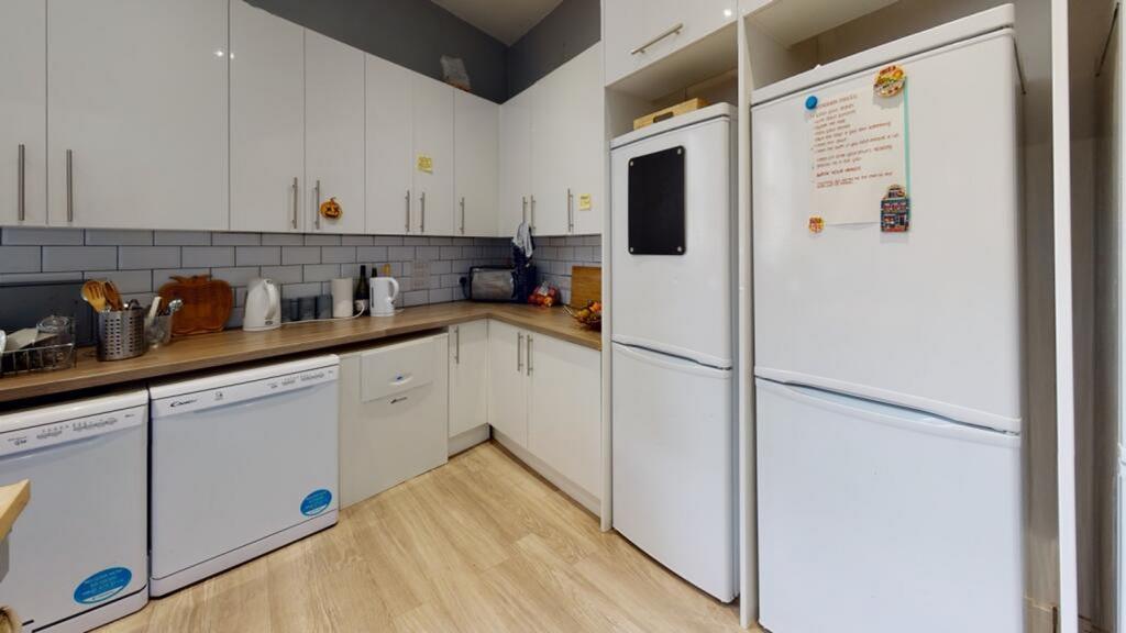 Modern kitchen featuring ample storage space an...