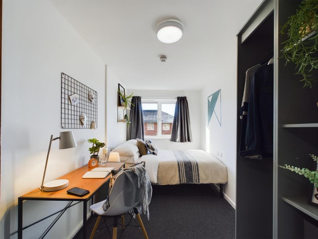 Bright and welcoming master bedroom featuring a...