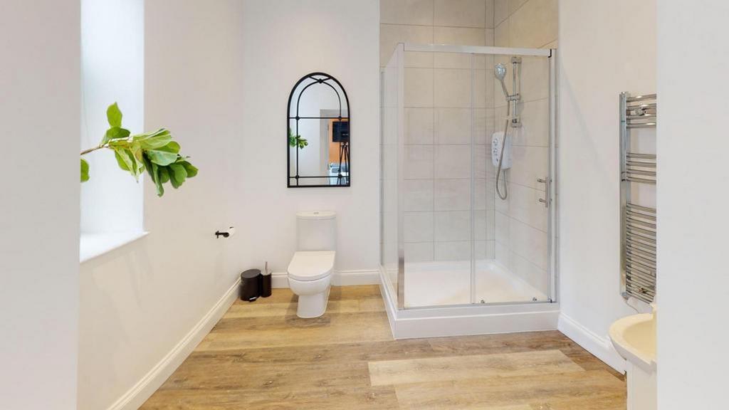 A bright and modern bathroom featuring a spacio...