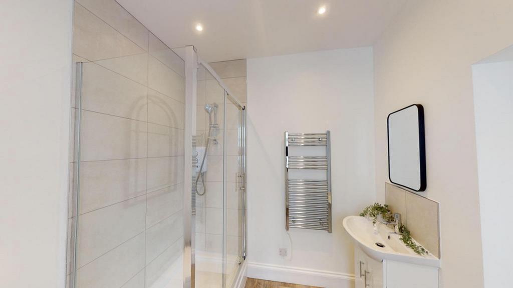 A modern and pristine bathroom featuring a spac...