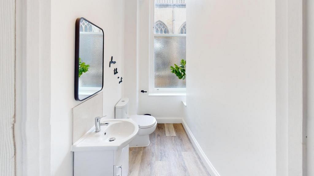 A bright and modern bathroom featuring stylish ...