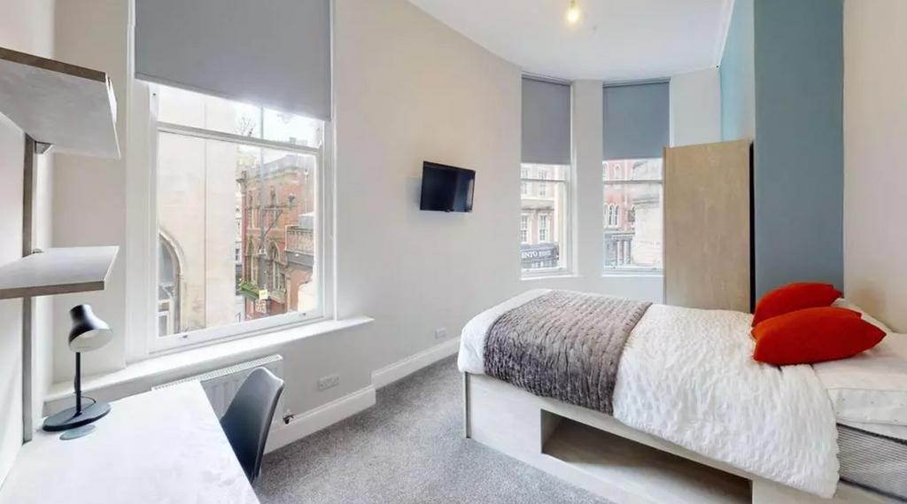 A bright and inviting double bedroom featuring ...
