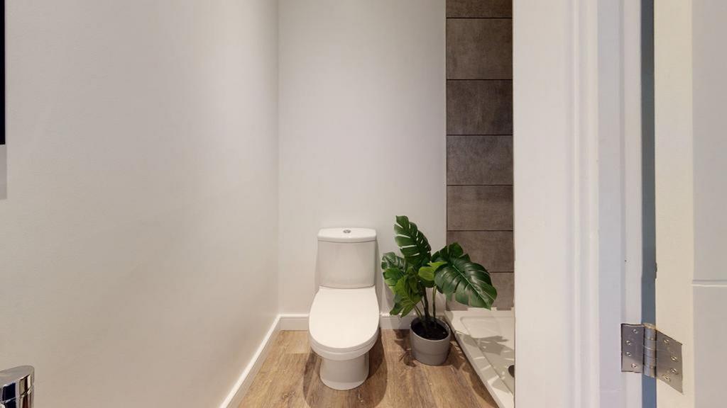 A tidy and modern single toilet with stylish de...