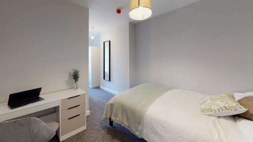 A stylish and well-lit double bedroom featuring...