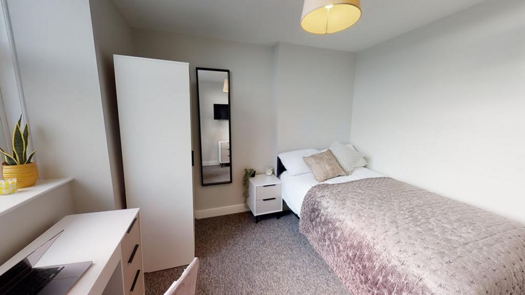 A bright and inviting double bedroom featuring ...