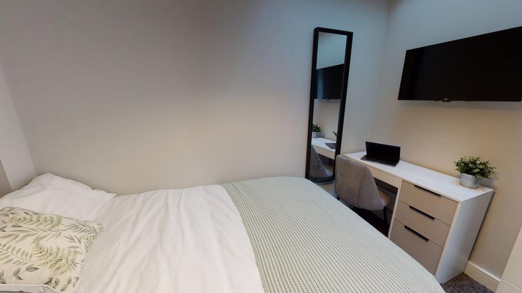 A bright and inviting double bedroom featuring ...