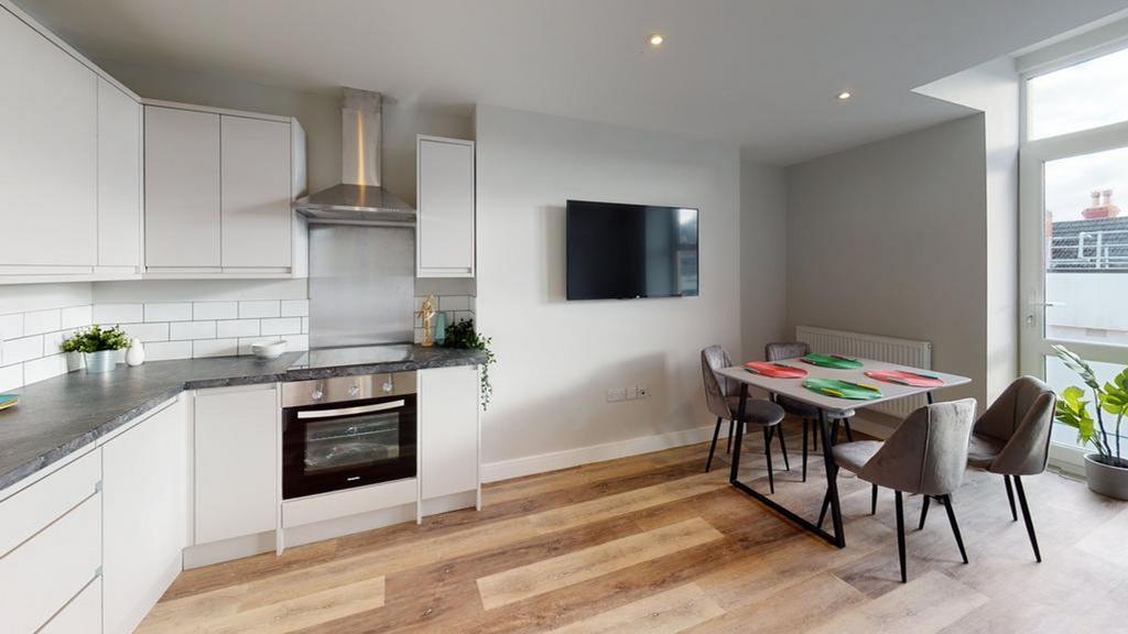 A modern and stylish kitchenette with ample spa...