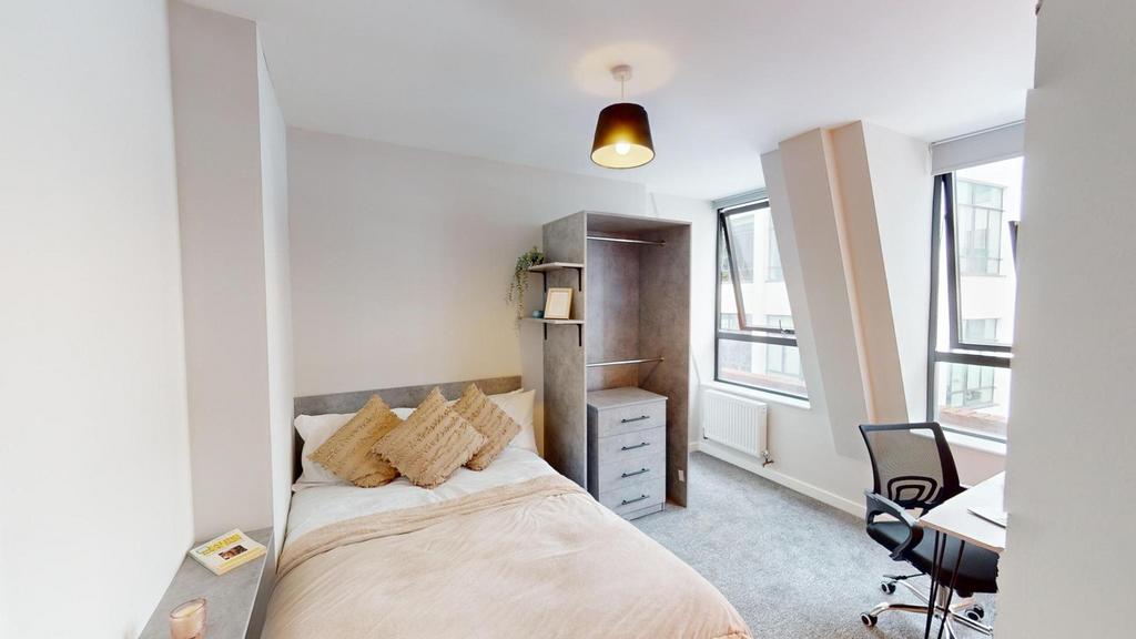A bright and inviting double bedroom featuring ...