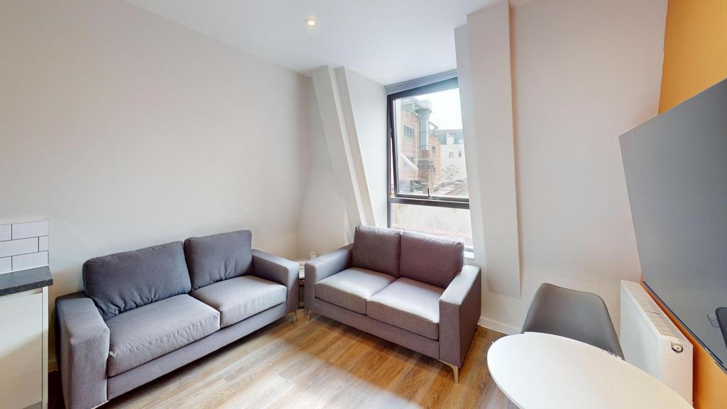 A spacious and inviting modern living room, per...