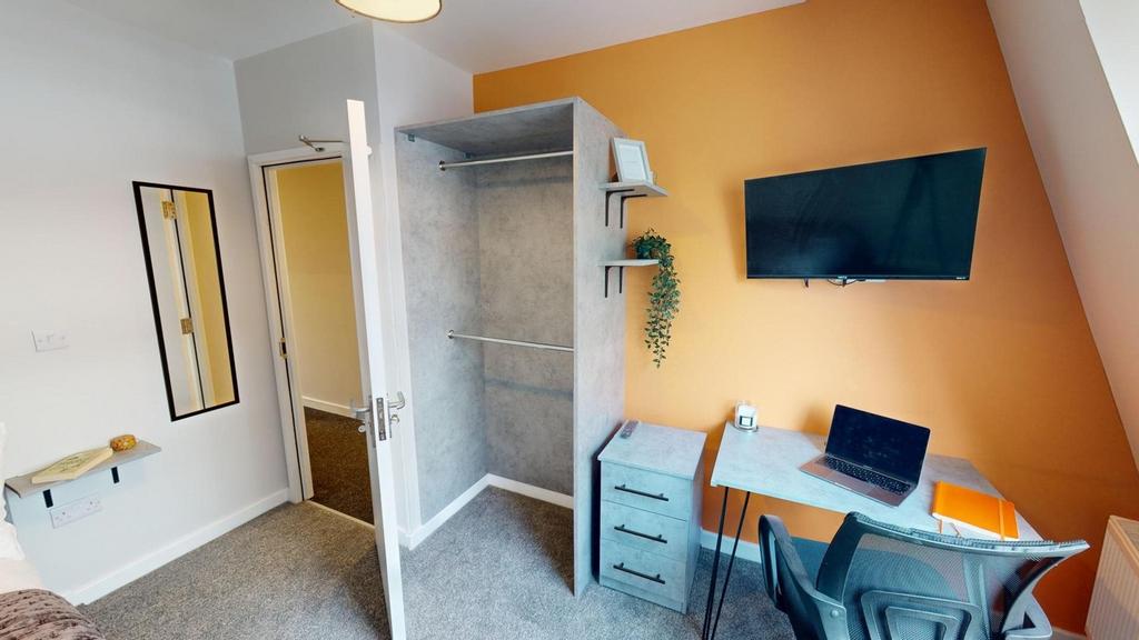 A stylish and tidy double bedroom featuring a w...