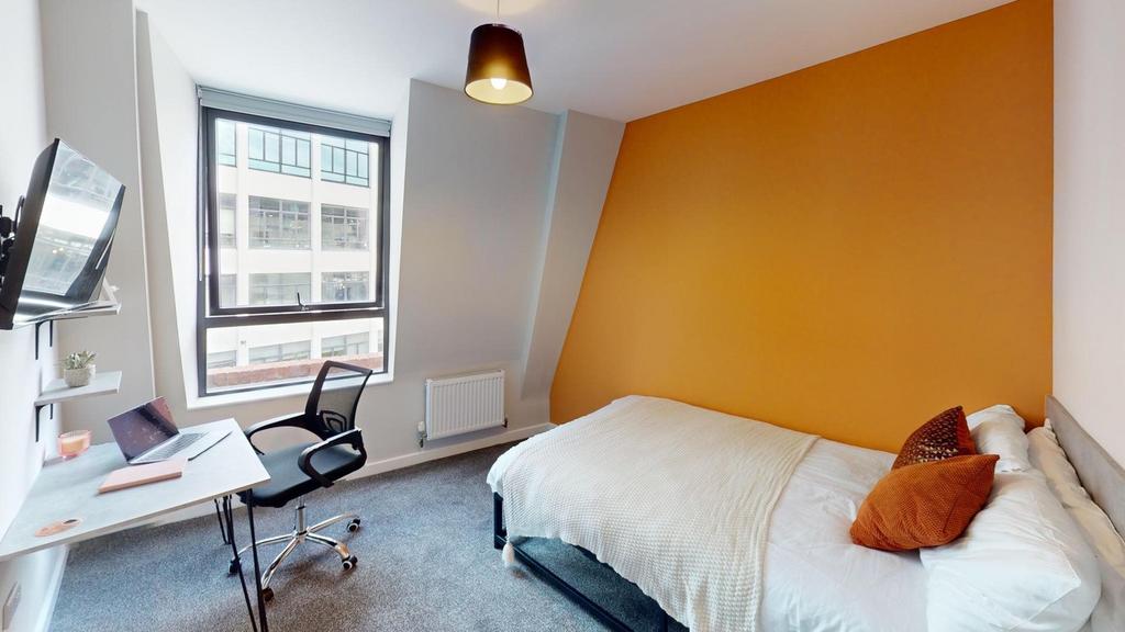 A bright and inviting double bedroom with moder...