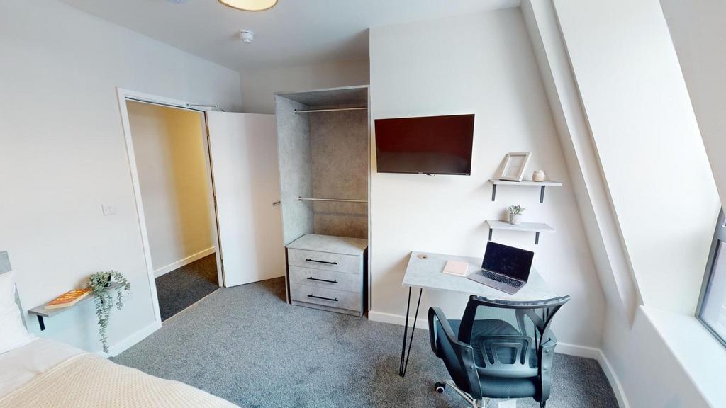 A bright and tidy double bedroom featuring a co...