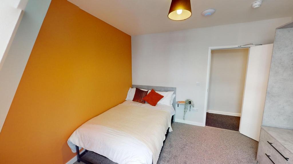 A bright and inviting double bedroom with moder...