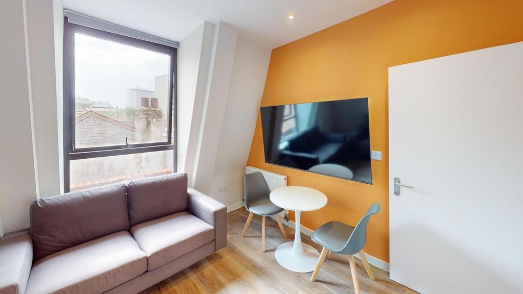 A bright and welcoming living room featuring mo...