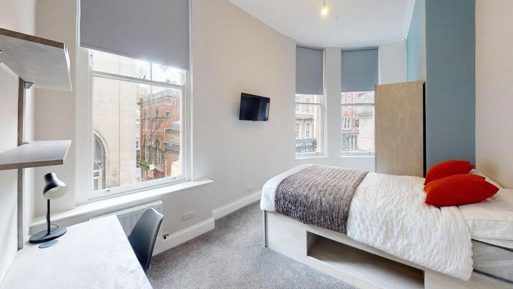 A bright and inviting double bedroom featuring ...
