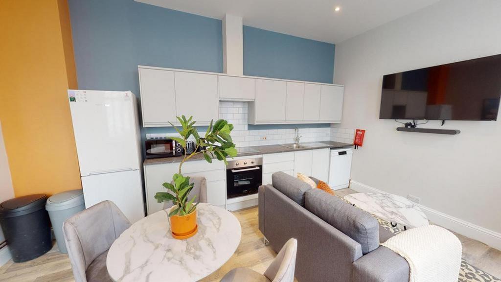 A modern kitchenette with ample space and brigh...