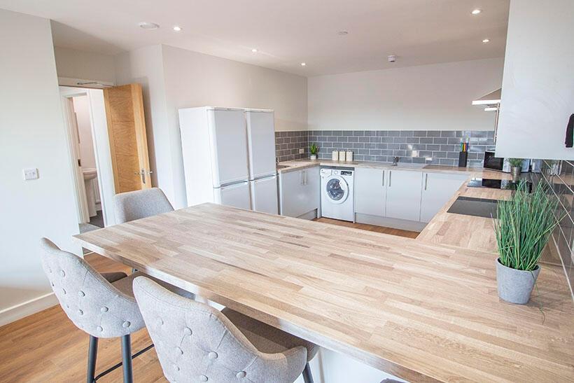 A modern and bright kitchen featuring a spaciou...