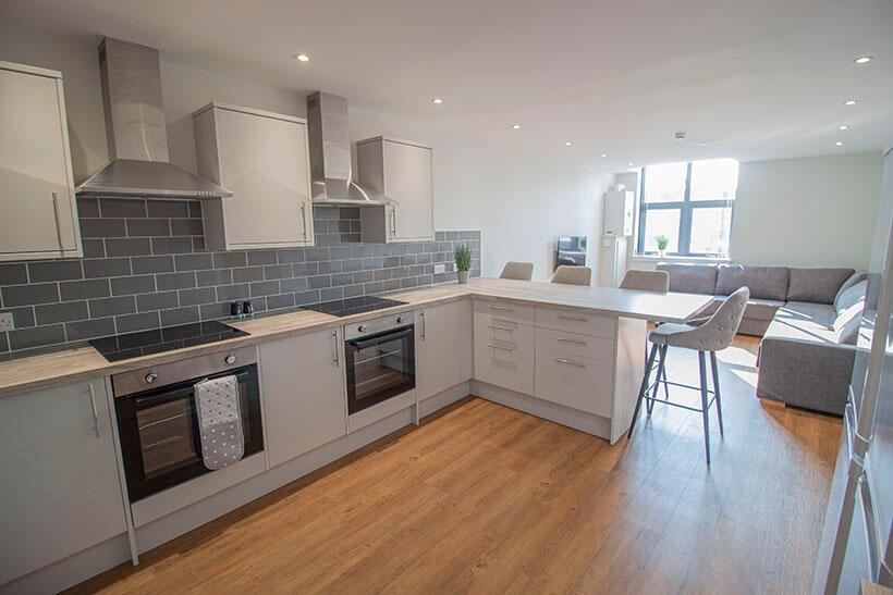 A bright, modern kitchen with sleek white cabin...