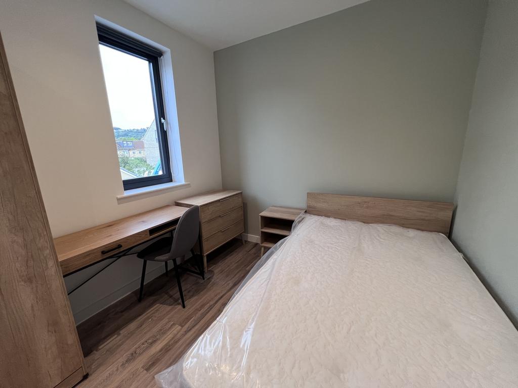A bright and inviting double bedroom featuring ...