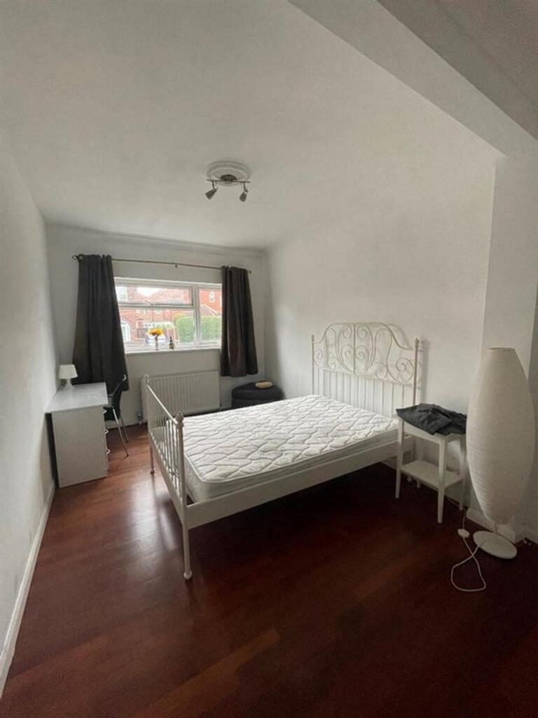 A bright and inviting double bedroom featuring ...