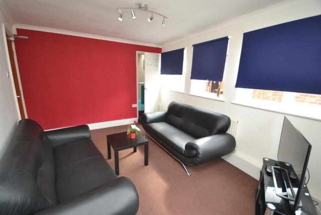 A cozy living room featuring stylish black sofa...