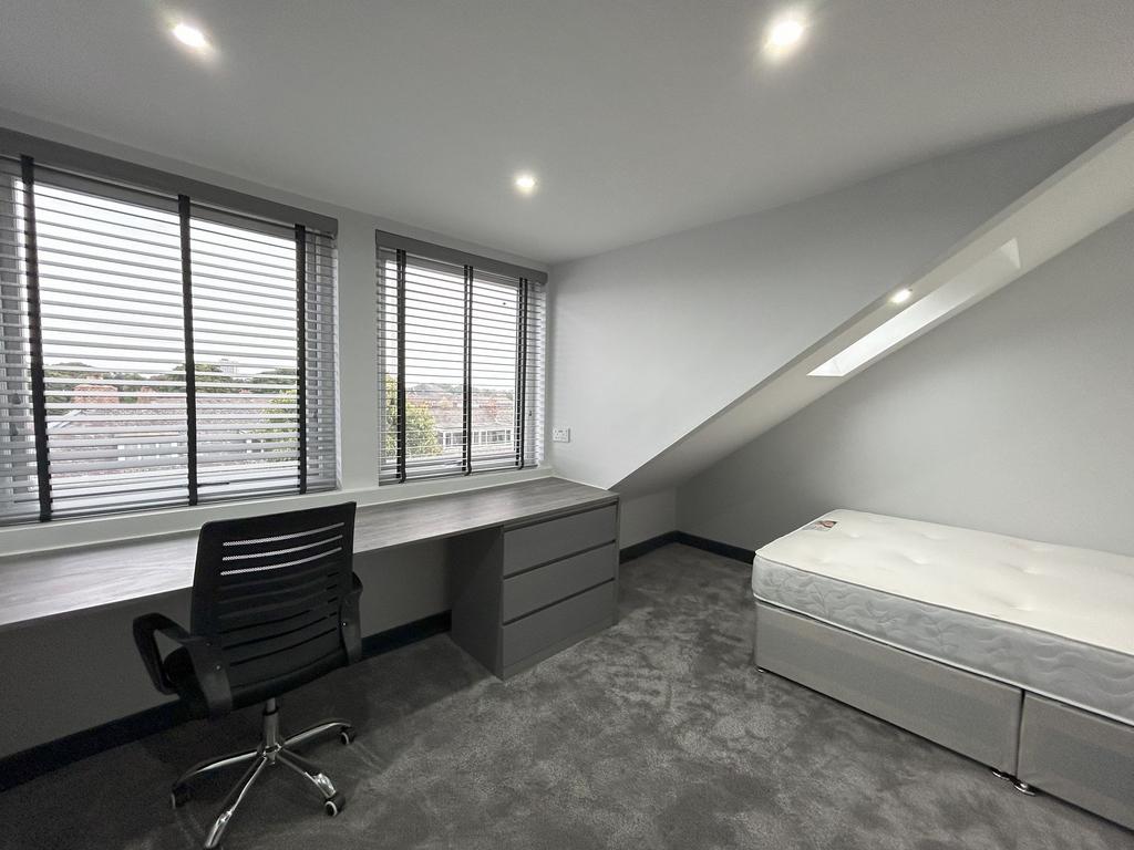 Bright and modern single bedroom featuring a sp...