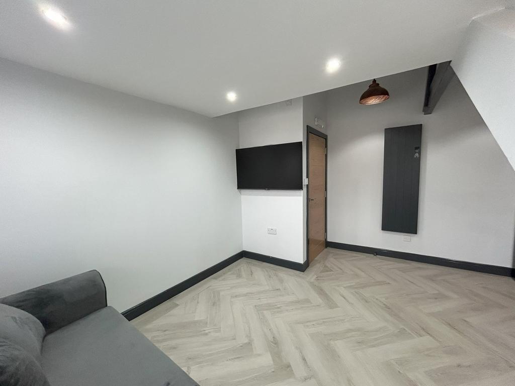 A modern living room featuring a clean, neutral...