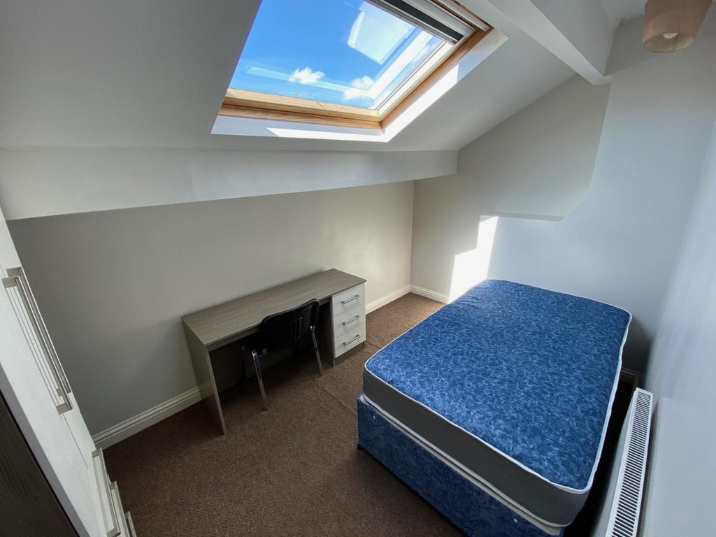 A bright and inviting double bedroom featuring ...