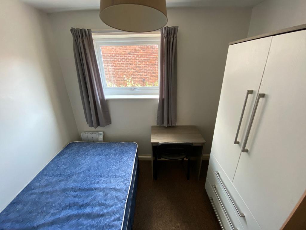 A cozy and well-lit double bedroom, perfect for...