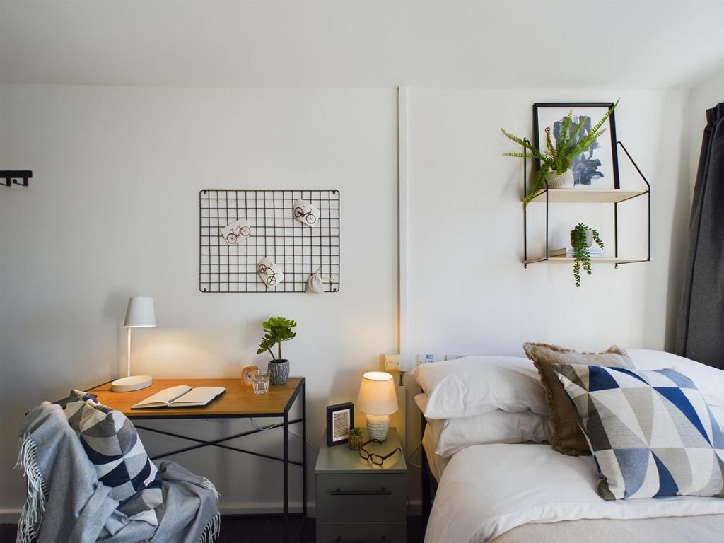 A stylish double bedroom featuring a comfortabl...