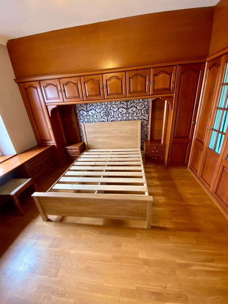 A charming double bedroom featuring solid wood ...