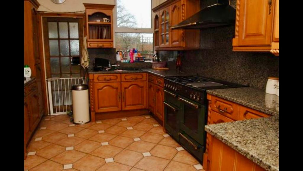 A warm and inviting kitchen featuring classic w...