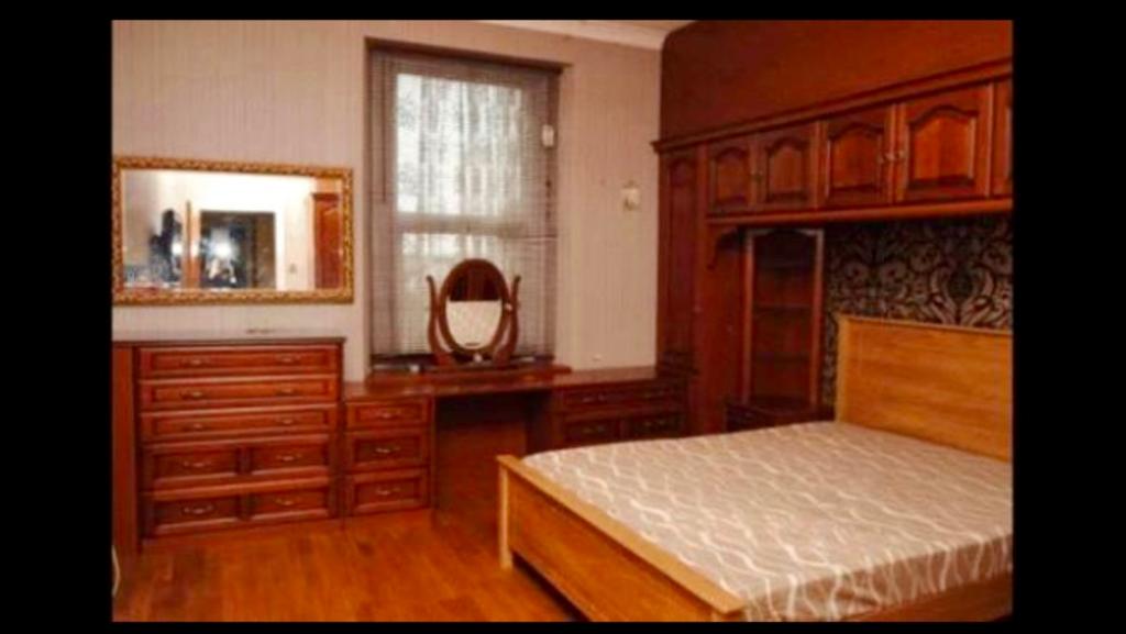 A cozy double bedroom featuring classic wooden ...