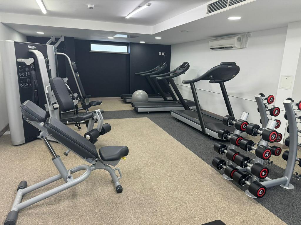A well-maintained gym featuring modern exercise...