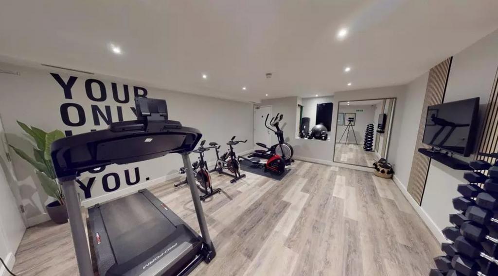 A spacious and modern gym area equipped with va...