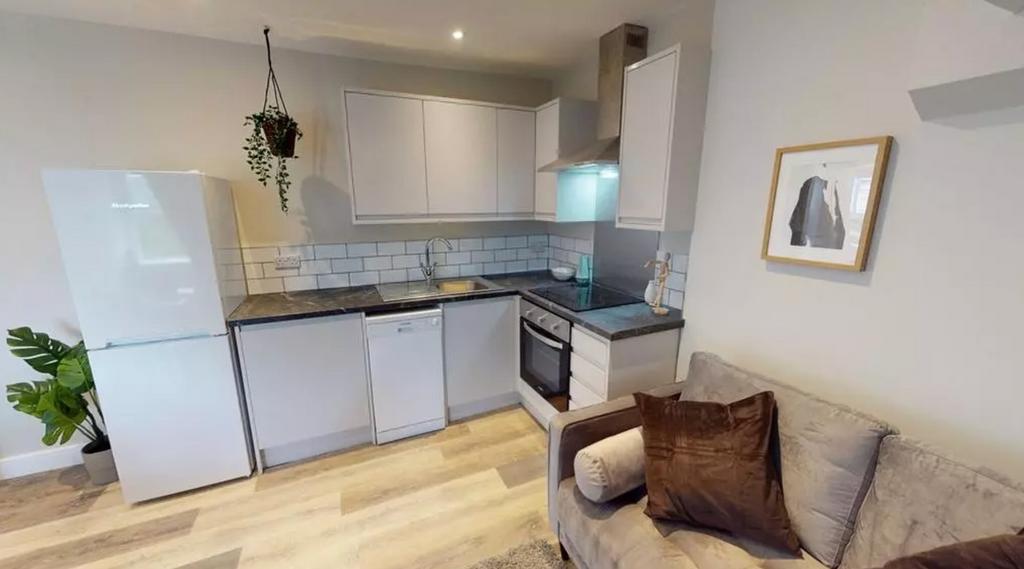 A modern and tidy kitchenette with ample space ...