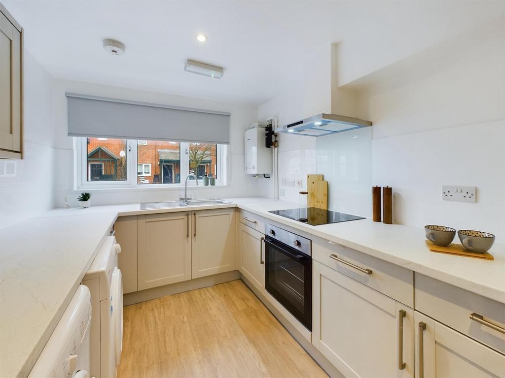 A bright and modern kitchen featuring ample cou...