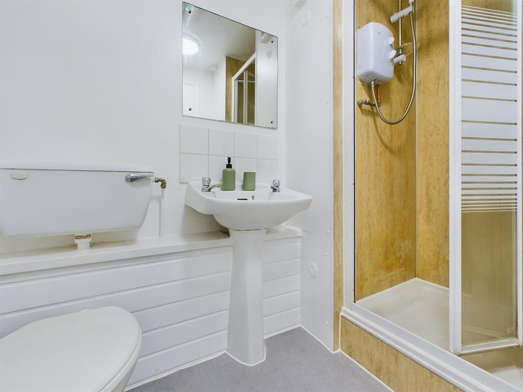 A bright and clean bathroom featuring a shower ...