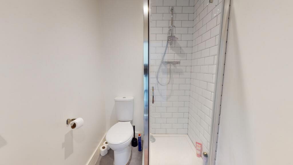 This modern bathroom features a stylish shower ...