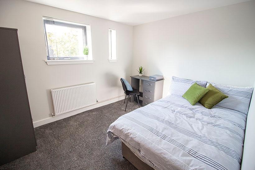 Bright and tidy double bedroom featuring a comf...