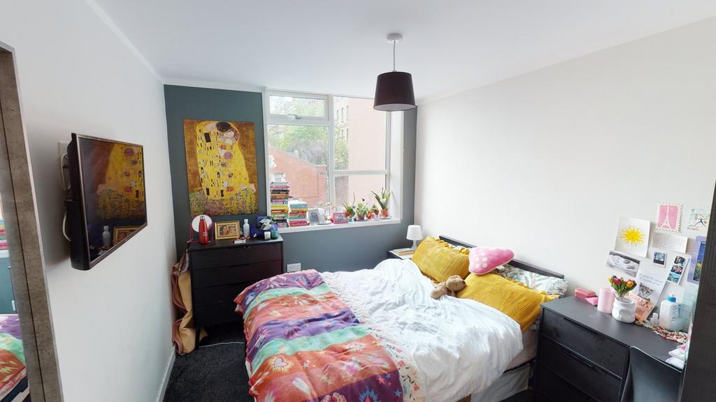 A bright and inviting double bedroom featuring ...