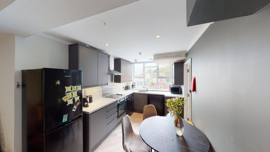 A modern and well-lit kitchenette featuring sle...