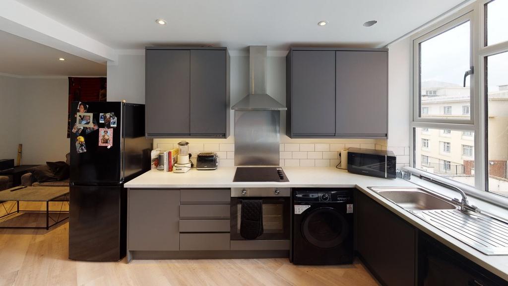 A modern and bright kitchenette featuring sleek...
