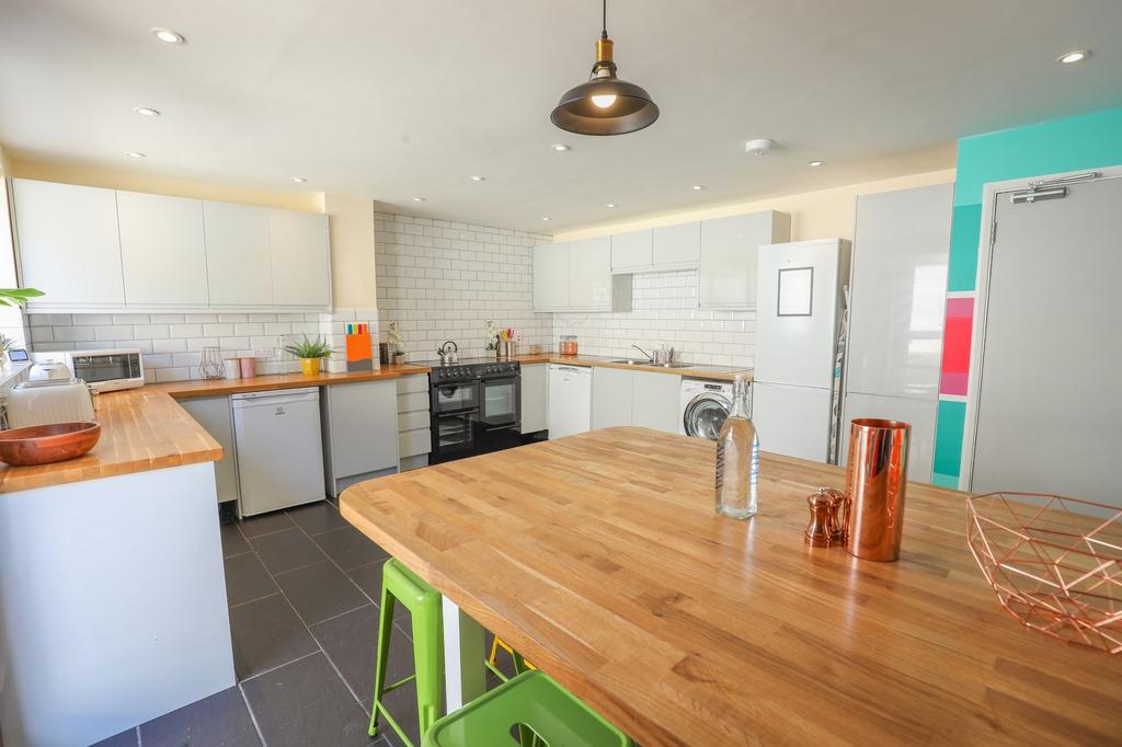 A modern kitchen featuring sleek cabinetry and ...