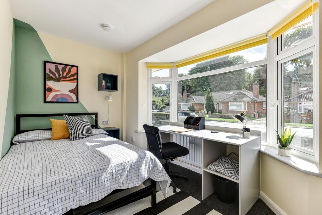 Bright and inviting double bedroom featuring la...