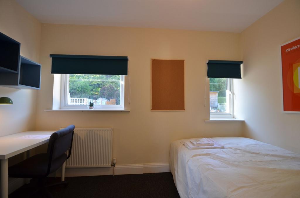Spacious double bedroom featuring large windows...