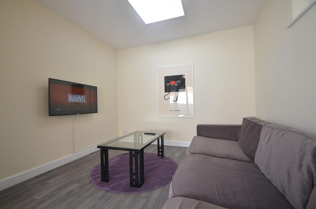 This inviting living room features a cozy sofa,...