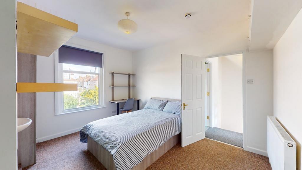 A bright and tidy double bedroom with a comfort...